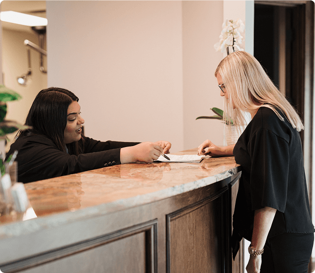Administrator consulting a patient at the counter
