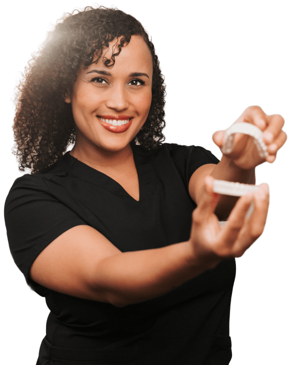 Woman holding a model of teeth