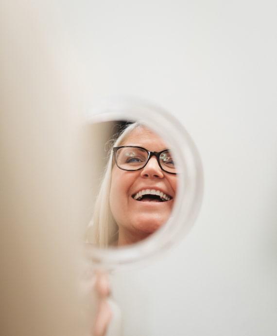 A photo of our patient smiling into the mirror