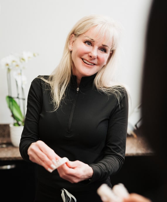 A photo of our smiling doctor while wearing her black uniform