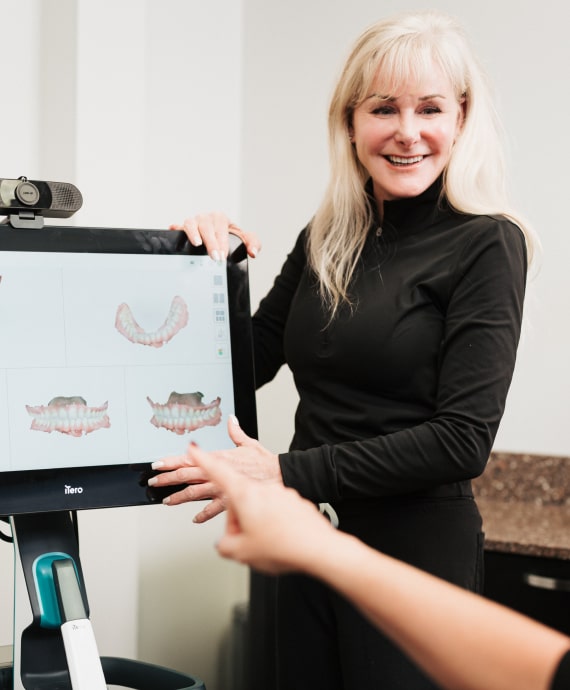 A photo of patient hand showing to the screen and smiling doctor stay close to it 