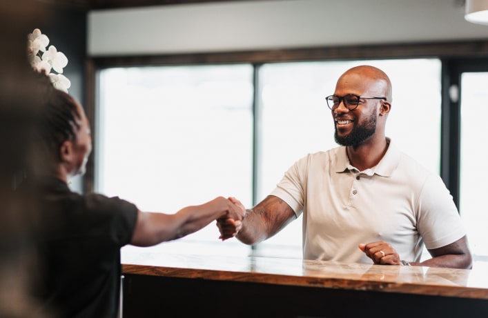A photo of team member and patient shacking hands