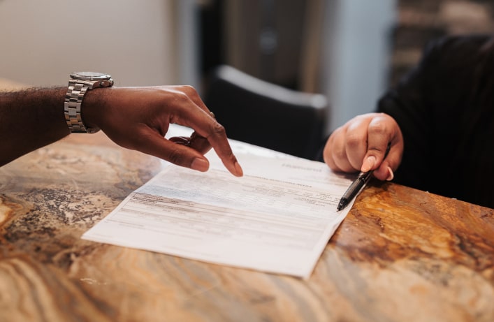 A photo of two hands and a paper