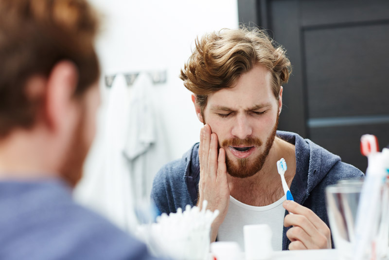 Dental Patient Suffering From Mouth Pain Caused By A Tooth Needing Extraction