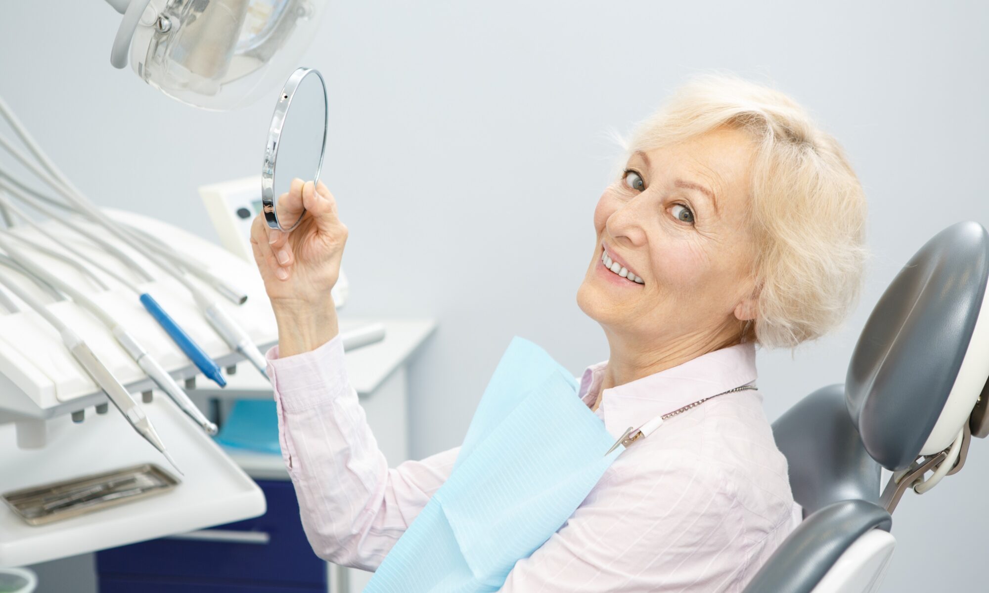woman sitting in dentist chair smiling