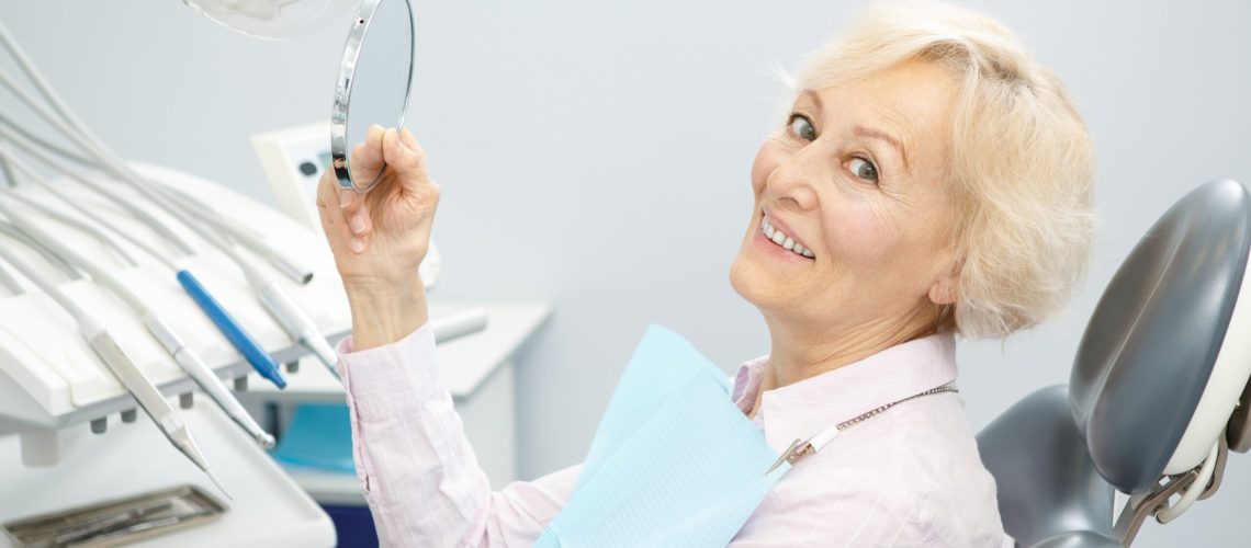 woman sitting in dentist chair smiling
