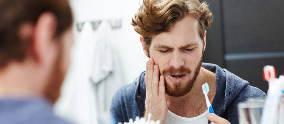 Dental Patient Suffering From Mouth Pain Caused By A Tooth Needing Extraction