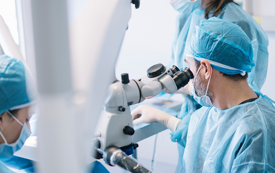 Dentist looking through a microscope