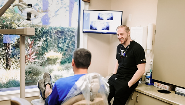 Doctor Holz smiling in a bow tie and white lab coat