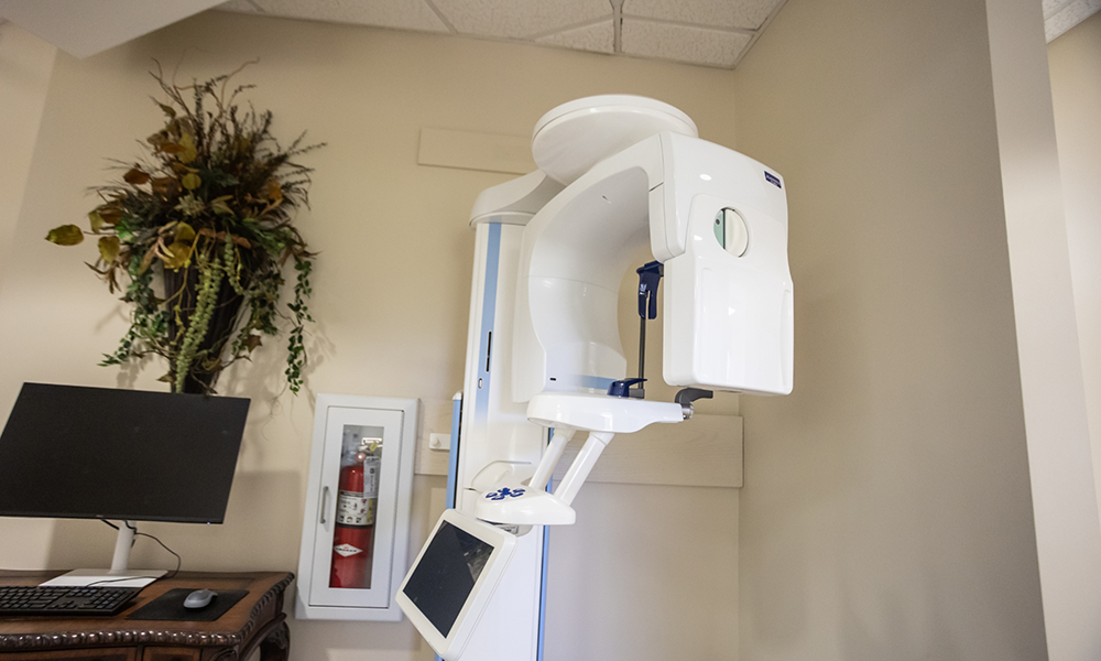 Dental treatment room with hedges visible through the window