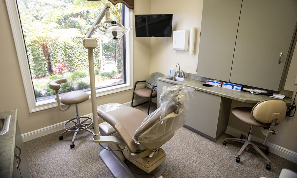 Yellow loveseat in dental office reception area