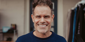 Smiling man in a dark blue T shirt