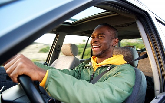 Man smiles while driving