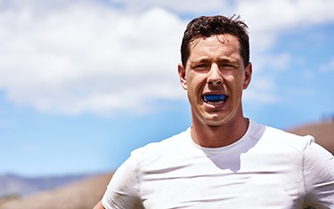 Man wears athletic mouthguard