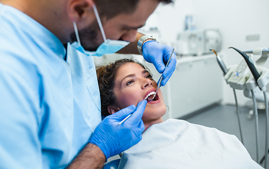 Woman having her teeth examined by her dentist