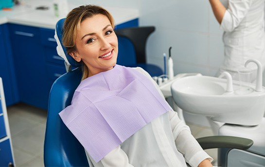 Woman smiling while sitting in treatment chair